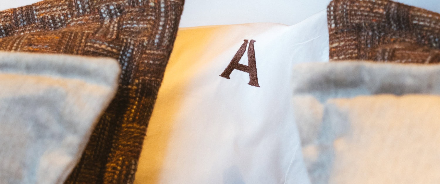 Sunreef Power Yacht Interior Luxurious yacht interior with plush bedding and stylish pillows.