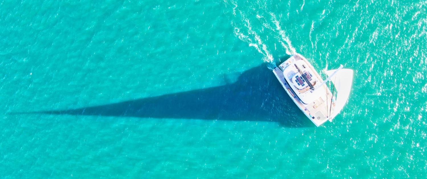 Luxury Sunreef 80 sailing yacht in turquoise waters.