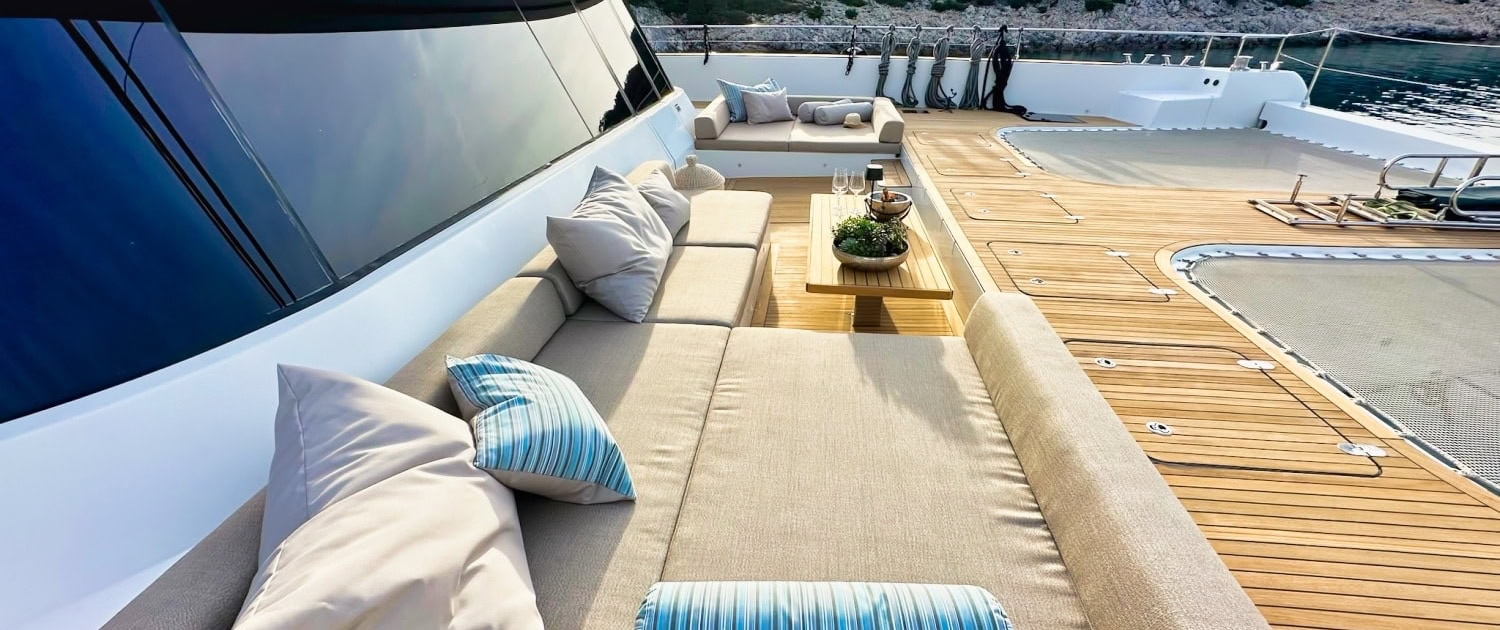 Luxurious Sunreef 80 yacht deck with outdoor lounge area and scenic ocean views.