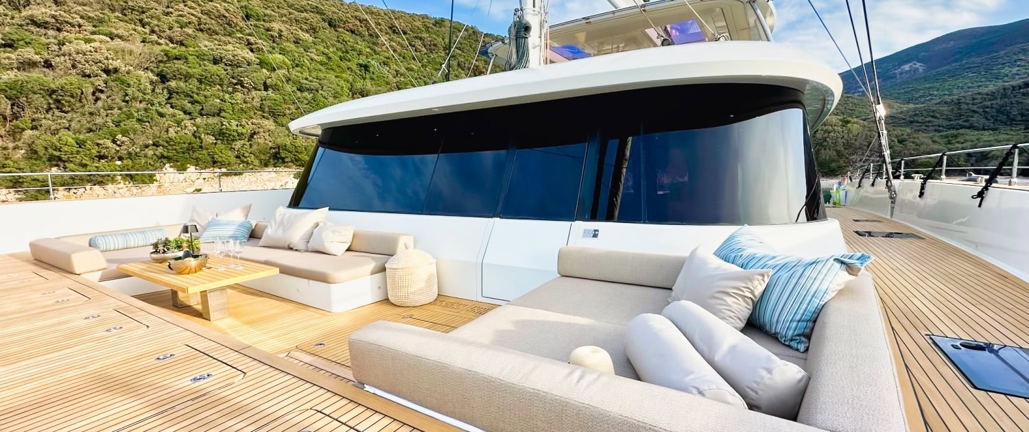 Luxury Sunreef 80 sailing yacht with spacious outdoor lounge area.