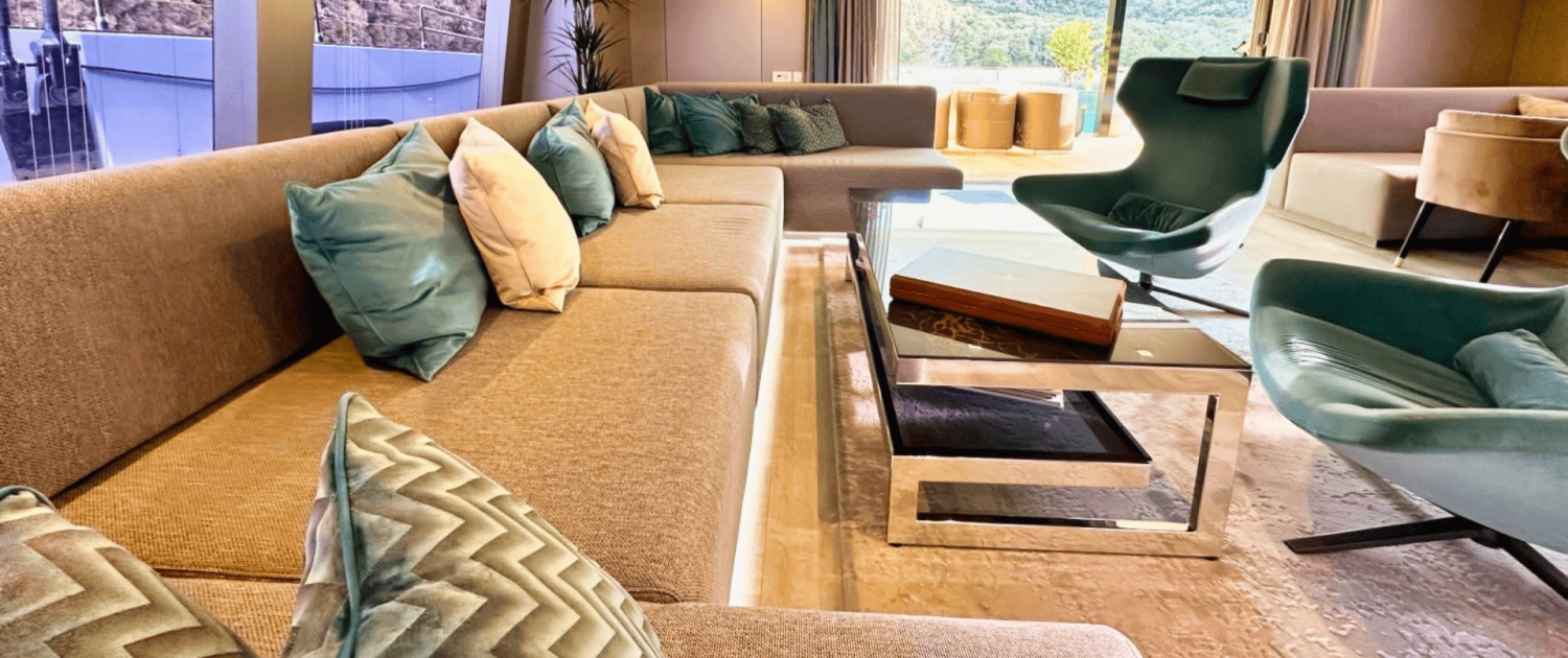 Luxury Sunreef 80 yacht lounge with modern seating and panoramic views.