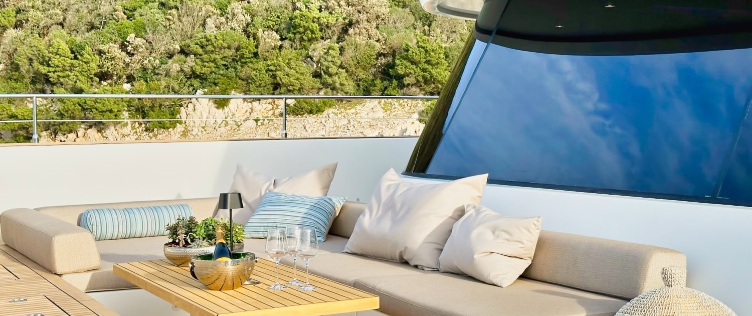 Luxury yacht sun deck with comfortable seating and scenic views.