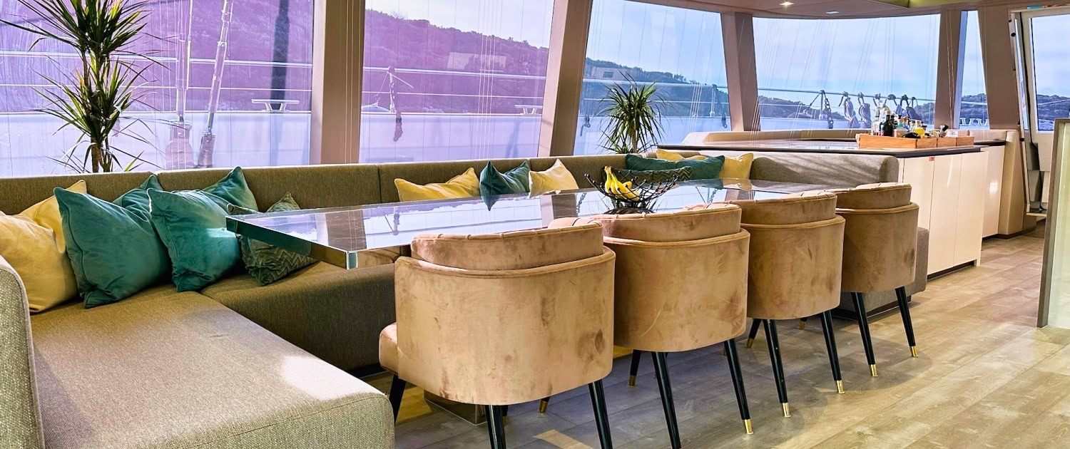 Luxury yacht interior with spacious seating and panoramic ocean views.