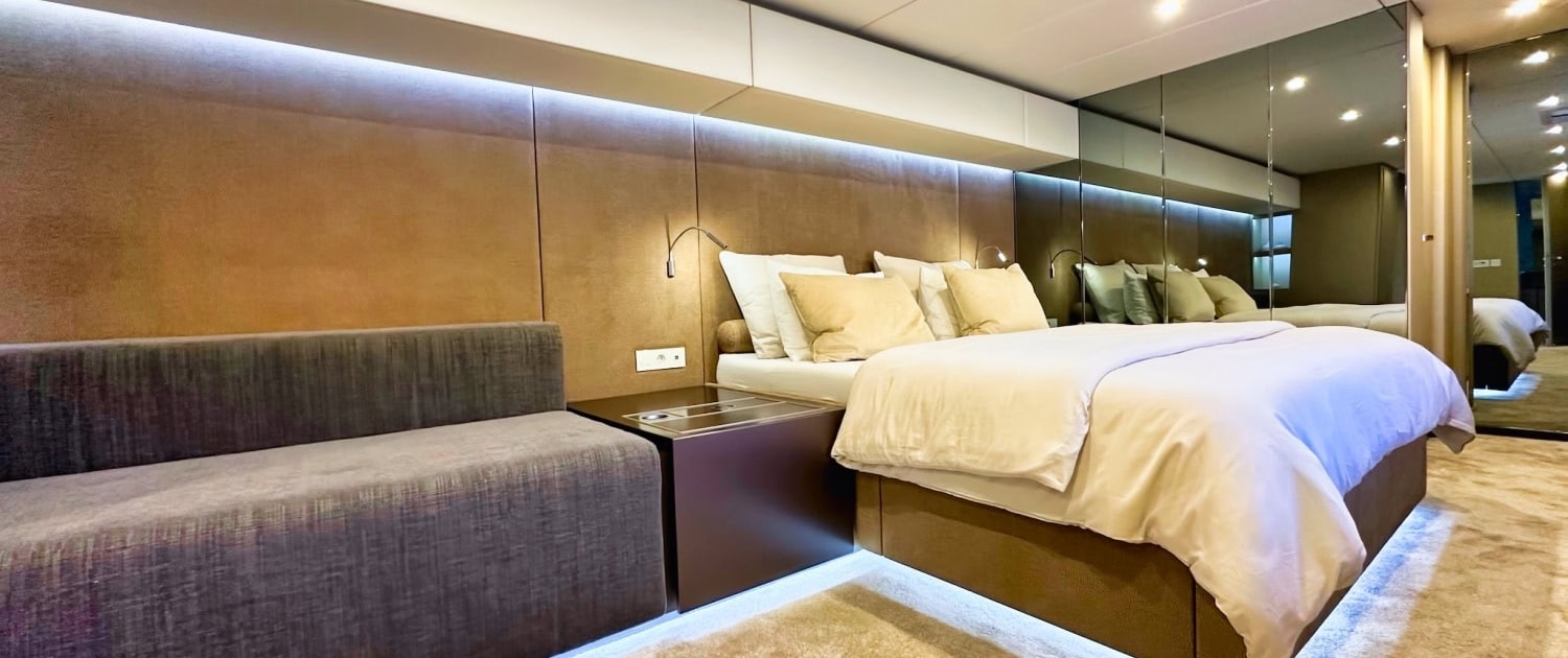 Luxury yacht interior with modern design and comfortable sleeping area.