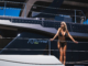 Woman in black bikini on Sunreef yacht deck, Croatia sailing destination.