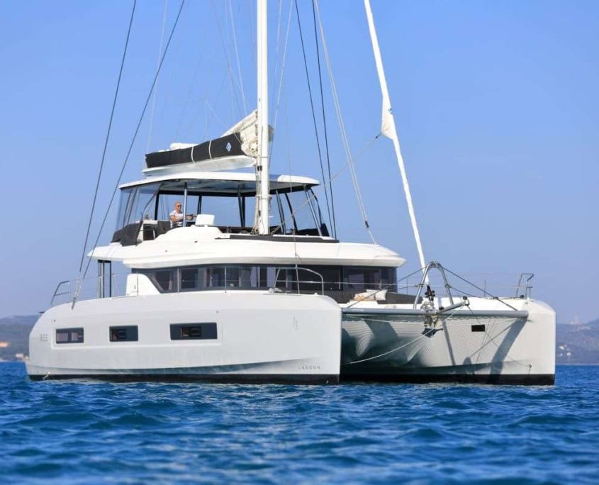 Lagoon 55 sailing yacht on blue waters, luxury cruising vessel.