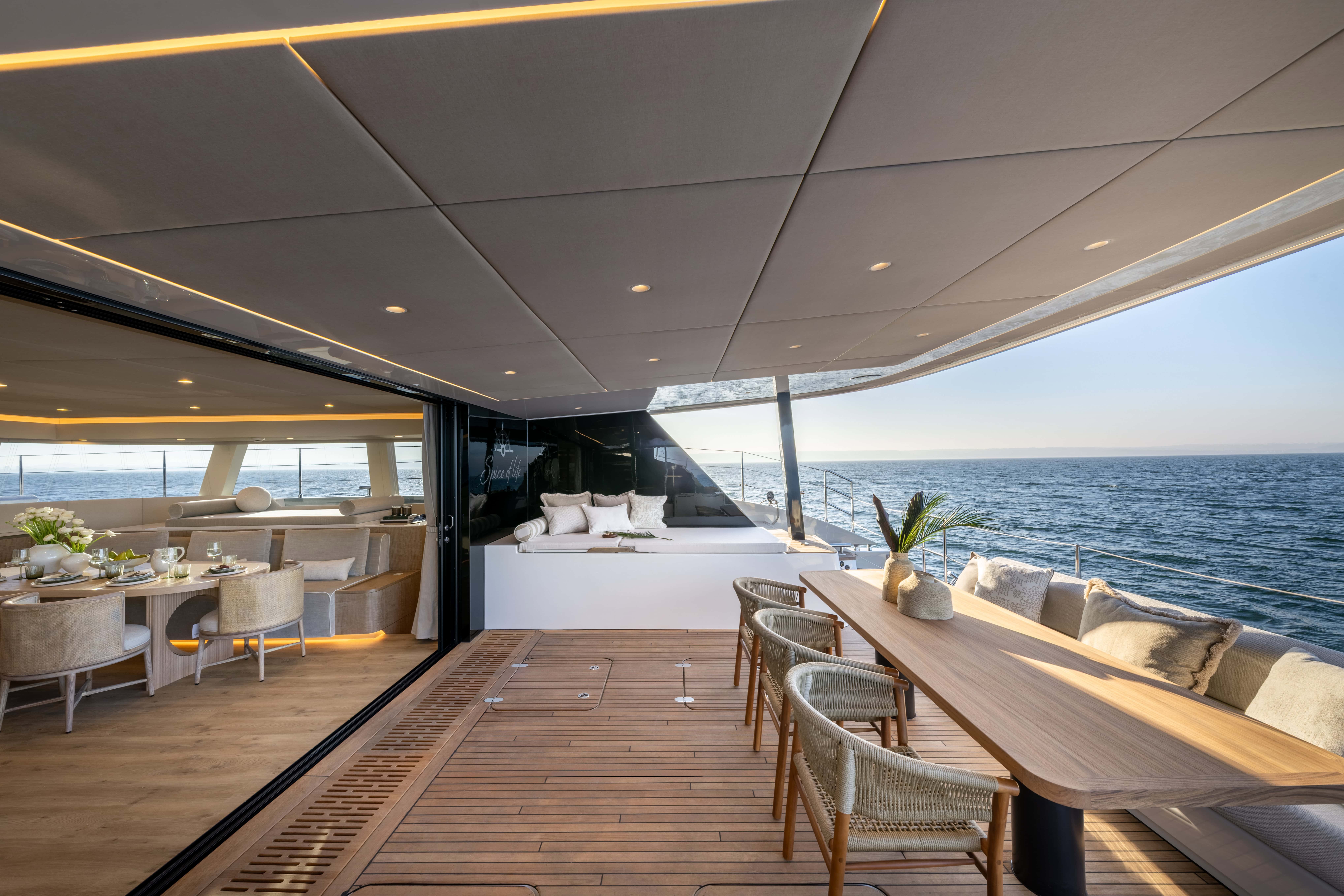 Spacious yacht deck with outdoor seating and ocean views.